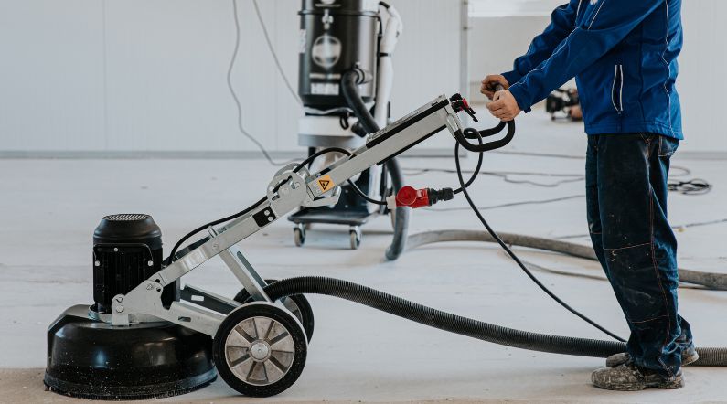 Grinder connected to dual HEPA vacuums for dust-free operation.